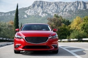 Auto rossa viaggia lungo la strada